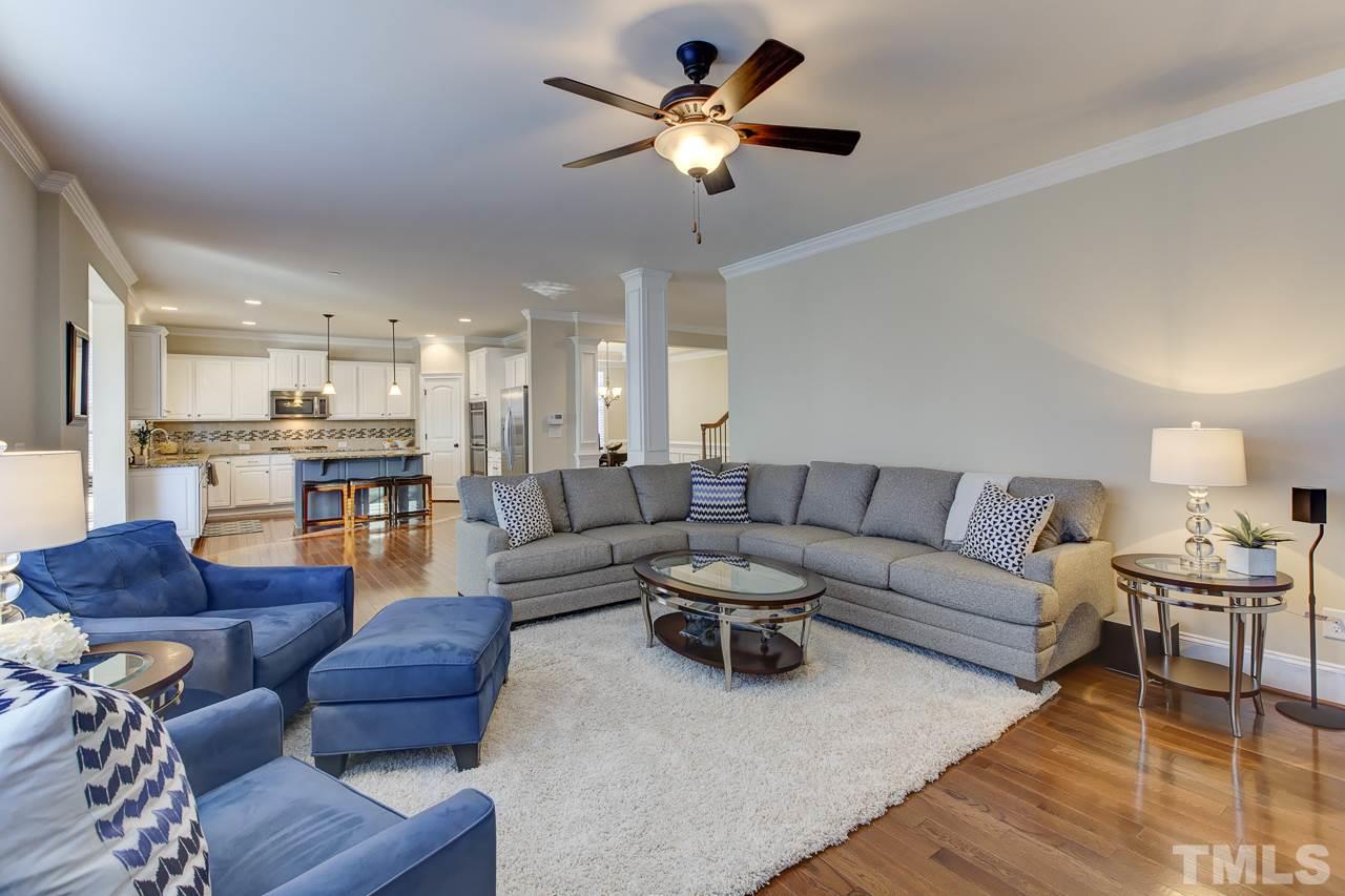 7319 Litchford Road Raleigh, NC 27615 - Photo 8 of 25 a living room with furniture kitchen view and a chandelier