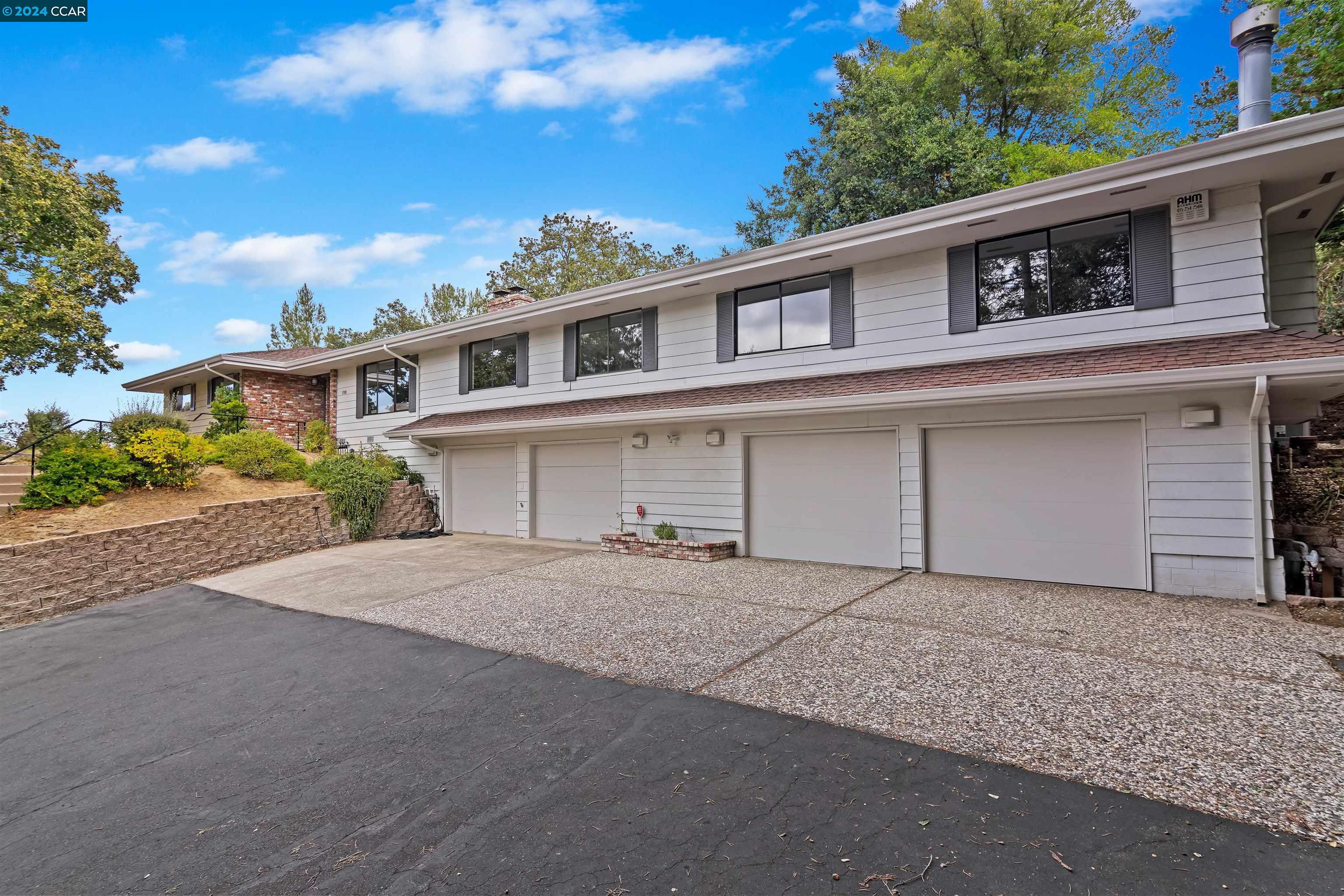 1760 Reliez Valley Road Lafayette, CA 94549 - Photo 1 of 1 a front view of a house with a yard and garage