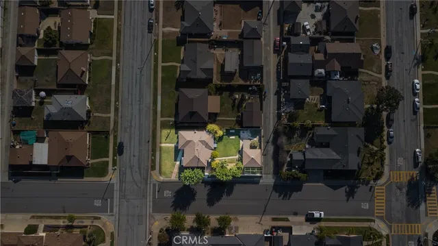 an aerial view of a residential apartment building with a yard and potted plants