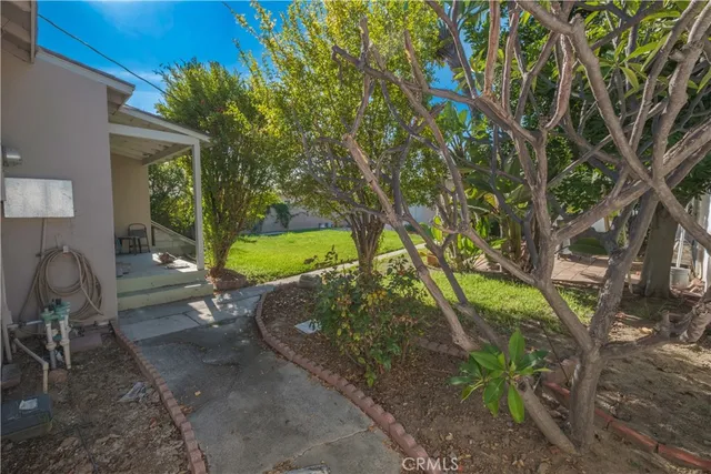 a backyard of a house with yard and outdoor seating