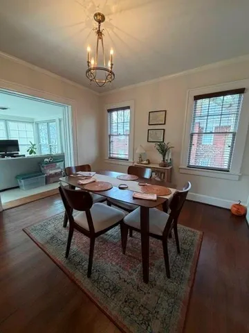a view of a dining room with furniture and window