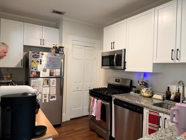 1365 North Highland Avenue Northeast, Unit B Atlanta, GA 30306 - Photo 5 of 11 a kitchen with kitchen island granite countertop a refrigerator stove top oven and sink with wooden floor