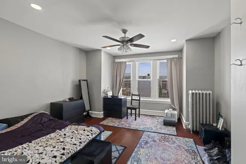 a view of a hallway with workspace and mirror