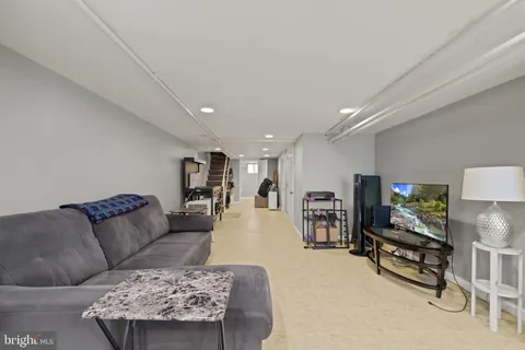 a bathroom with a toilet sink vanity and mirror