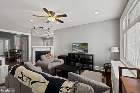 a living room with furniture a fireplace and a window