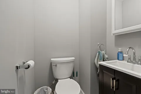 a bathroom with a toilet a sink and mirror