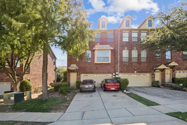 a car parked in front of a brick house