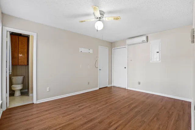 a view of an empty room with wooden floor