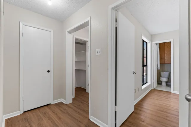 a view of hallway with wooden floor