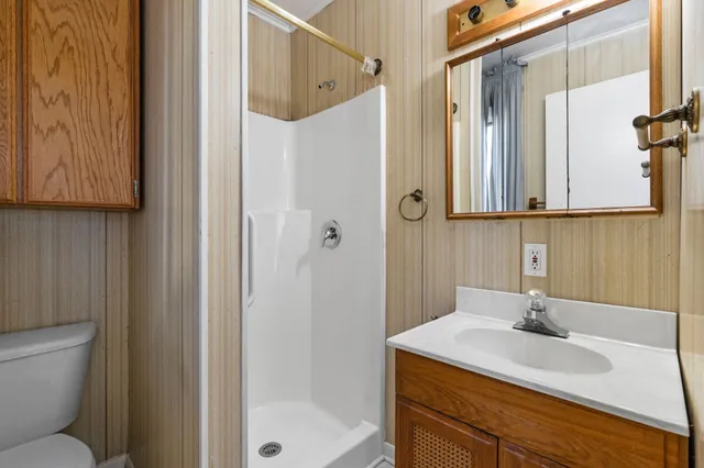 a bathroom with a sink toilet and shower