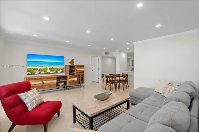 a kitchen with stainless steel appliances granite countertop a dining table chairs and white cabinets