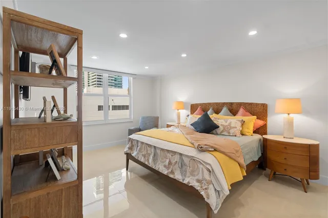 a bathroom with a toilet sink vanity and shower