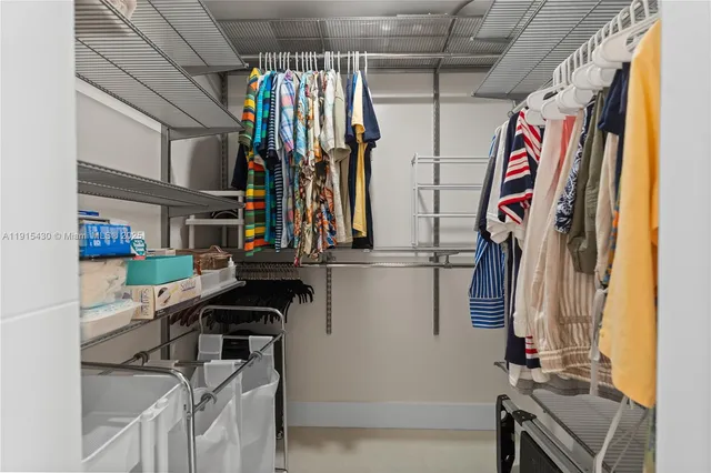 a kitchen with granite countertop a stove top oven microwave and cabinets