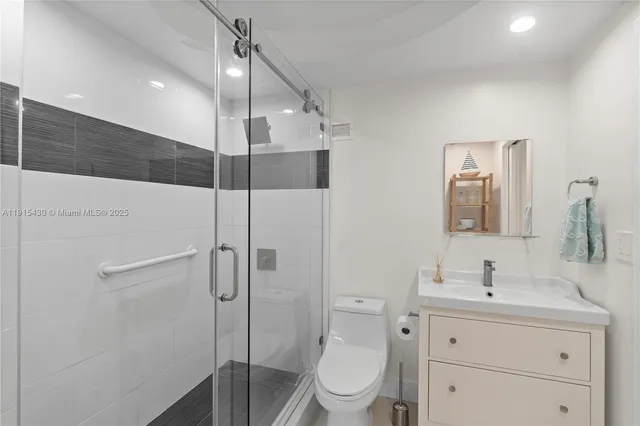 a metallic refrigerator freezer and a stove sitting inside of a kitchen