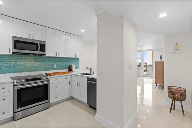 a kitchen with a sink stove and microwave