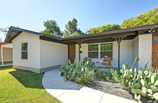 a front view of a house with garden