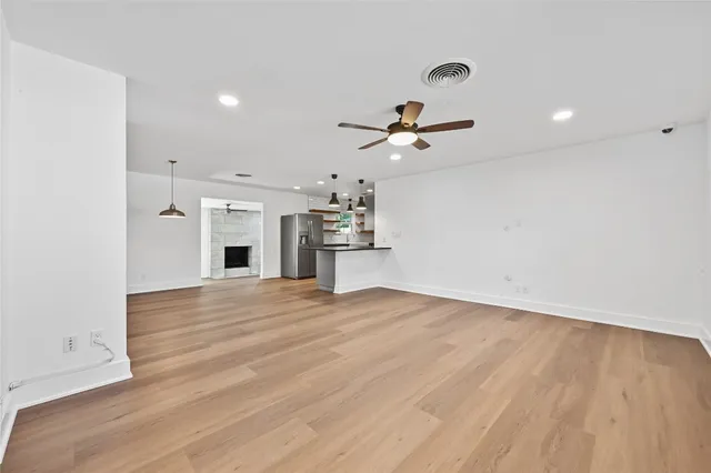 a view of a kitchen with a sink and a refrigerator