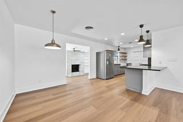 a view of kitchen with refrigerator microwave and stove