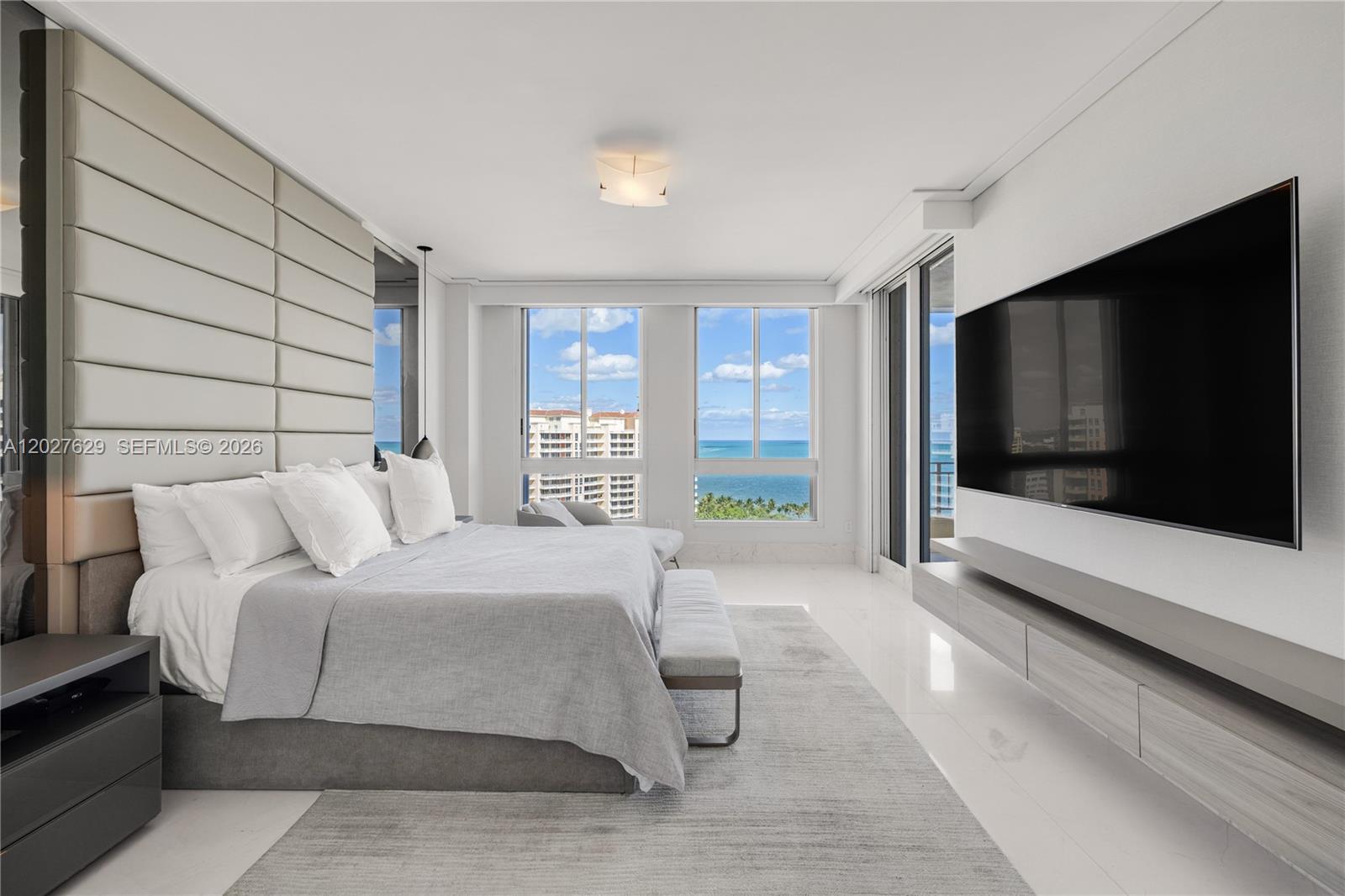 799 Crandon Boulevard, Unit PH8 Key Biscayne, FL 33149 - Photo 12 of 47 a spacious bedroom with a bed and a flat screen tv