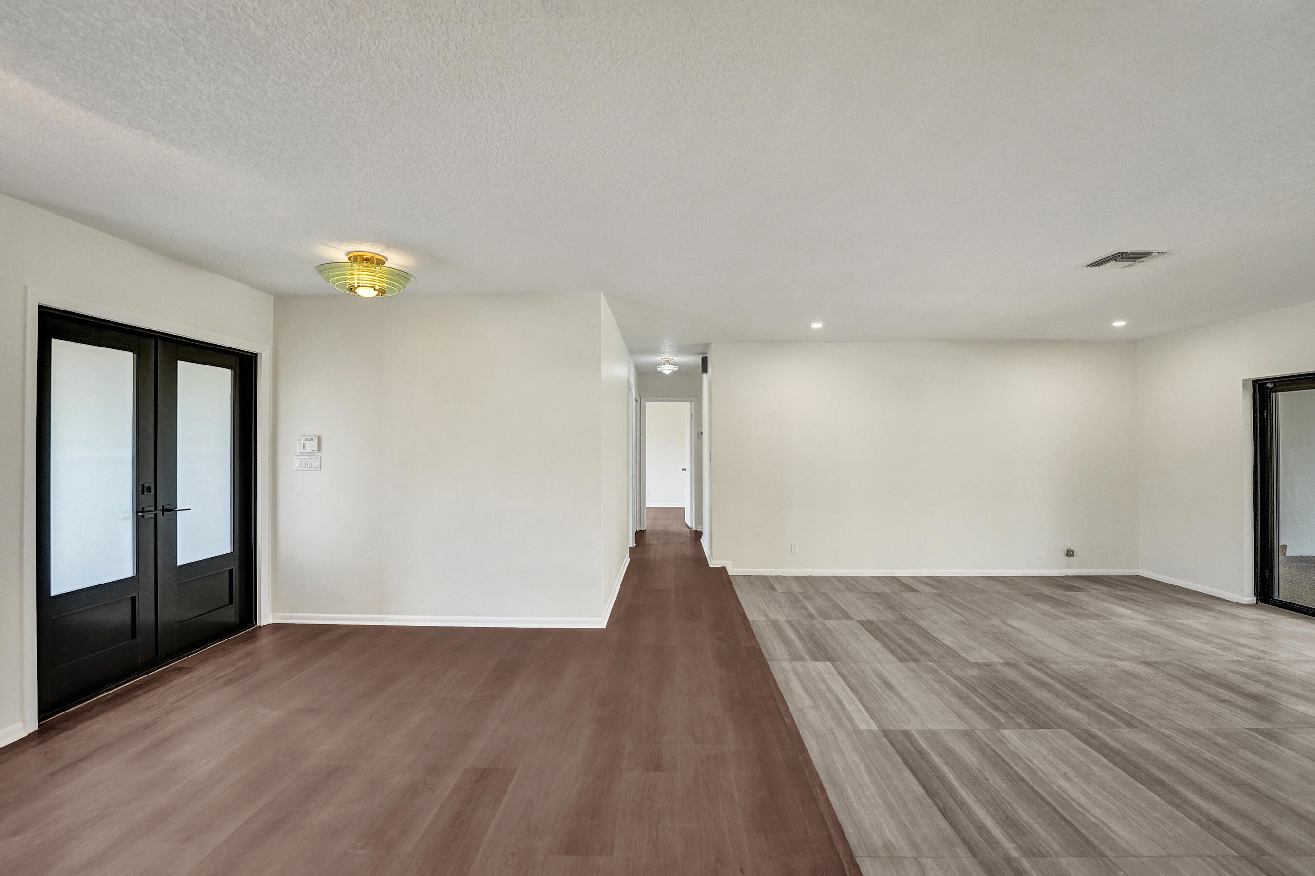 1321 Southwest 74th Terrace Plantation, FL 33317 - Photo 16 of 59 a view of an empty room with wooden floor and a window