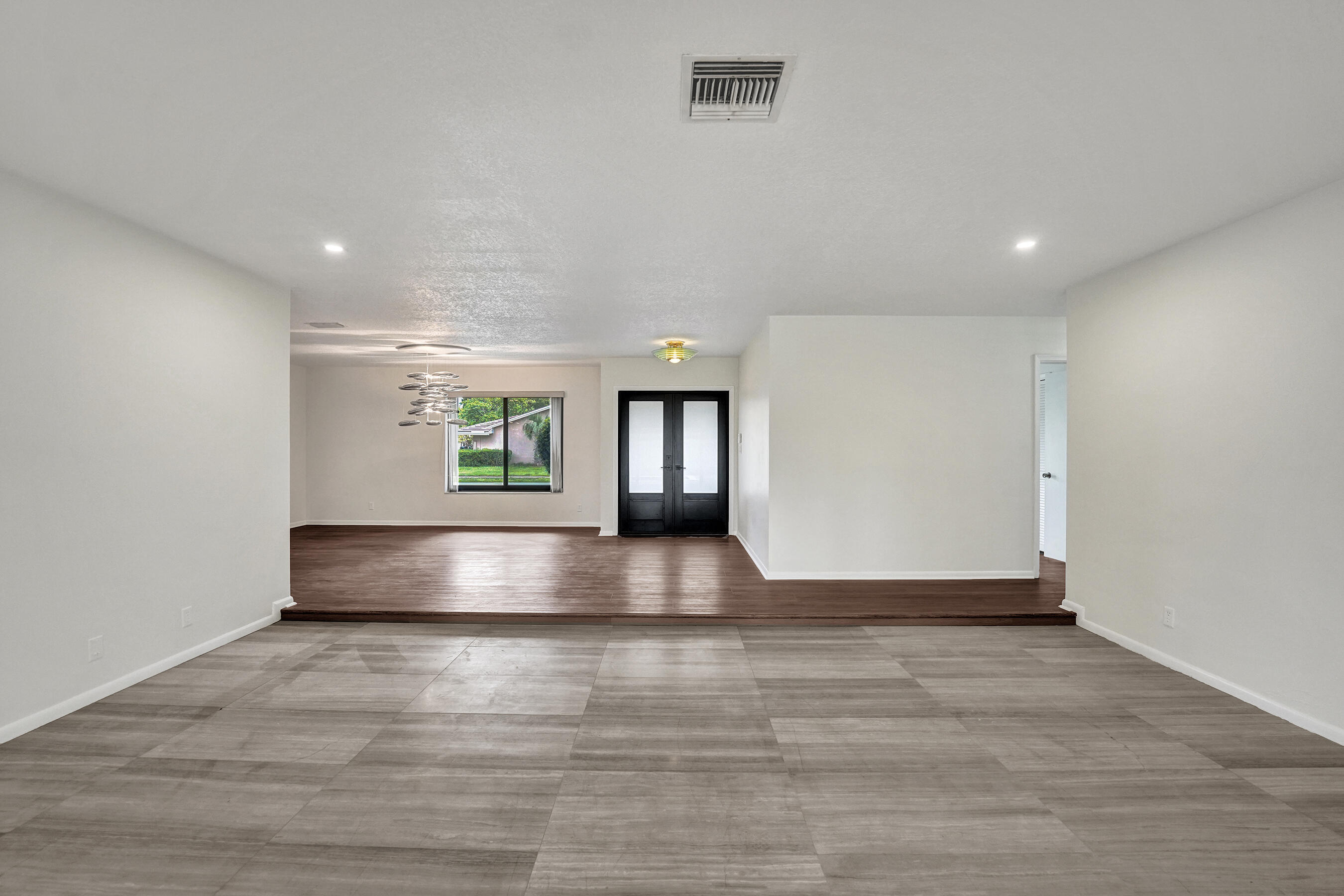 1321 Southwest 74th Terrace Plantation, FL 33317 - Photo 20 of 59 a view of an empty room with window and wooden floor