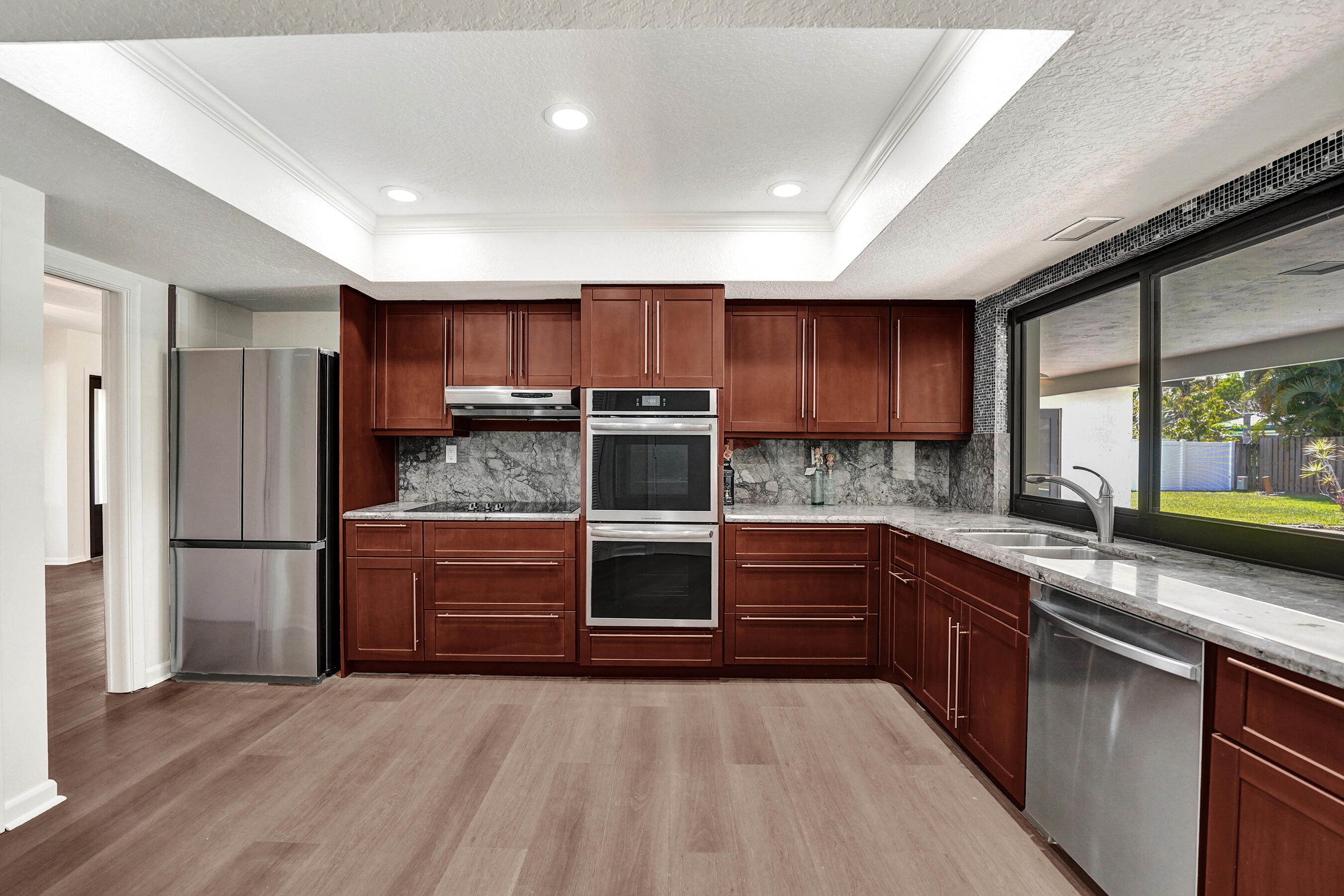 1321 Southwest 74th Terrace Plantation, FL 33317 - Photo 2 of 59 a kitchen with stainless steel appliances granite countertop a refrigerator and a sink