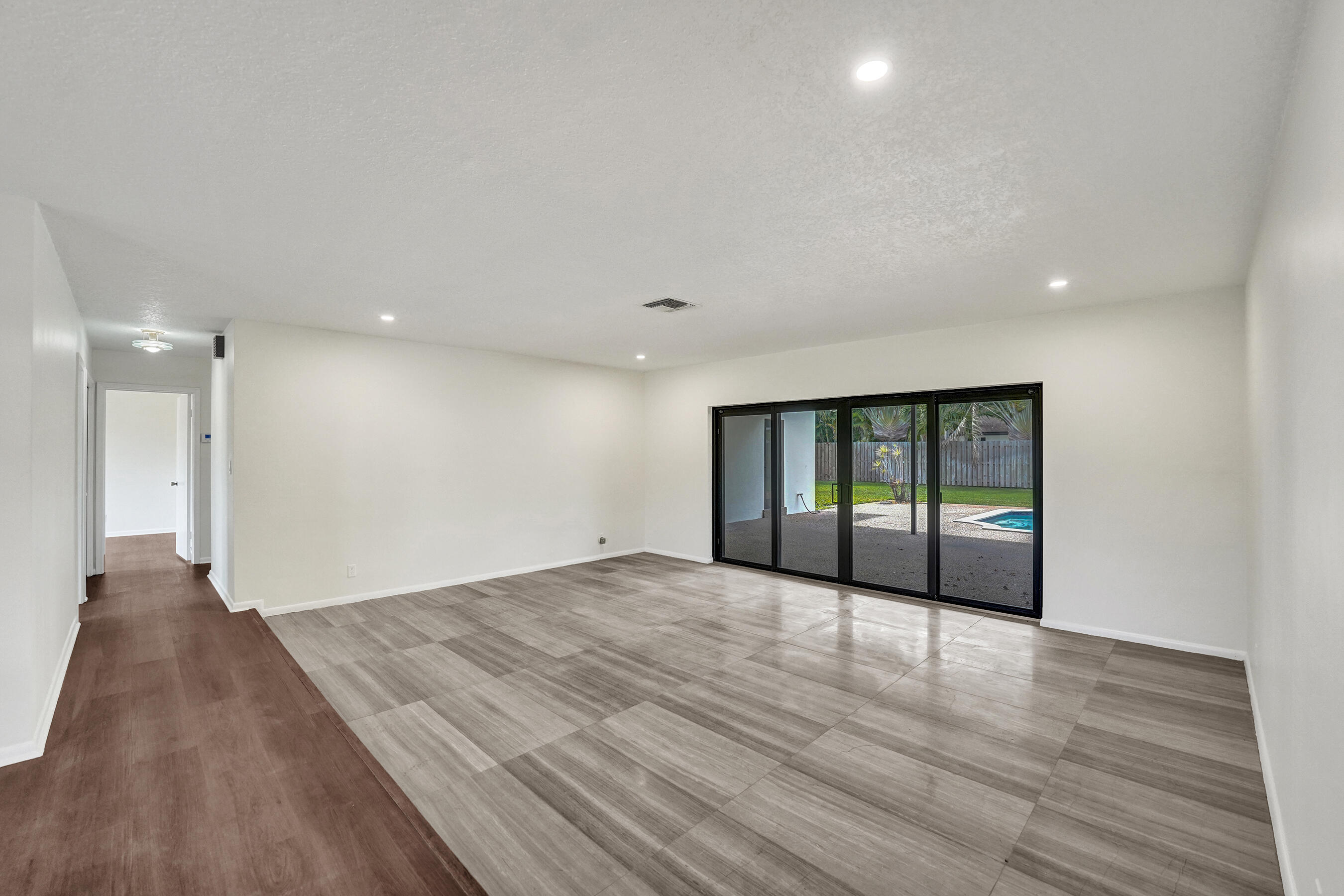 1321 Southwest 74th Terrace Plantation, FL 33317 - Photo 22 of 59 a view of an empty room with wooden floor and a window