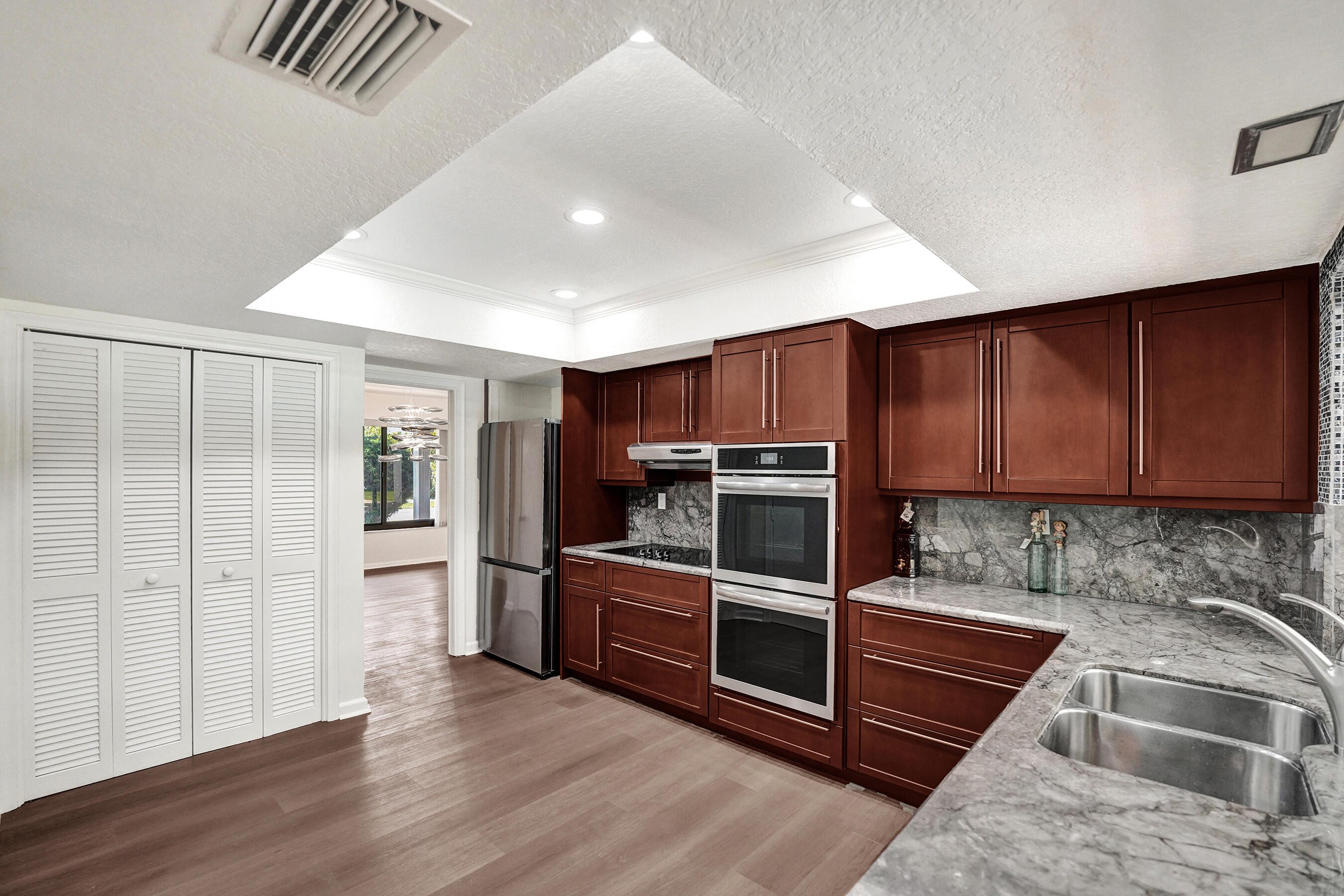 1321 Southwest 74th Terrace Plantation, FL 33317 - Photo 26 of 59 a kitchen with stainless steel appliances granite countertop a stove a sink and a microwave