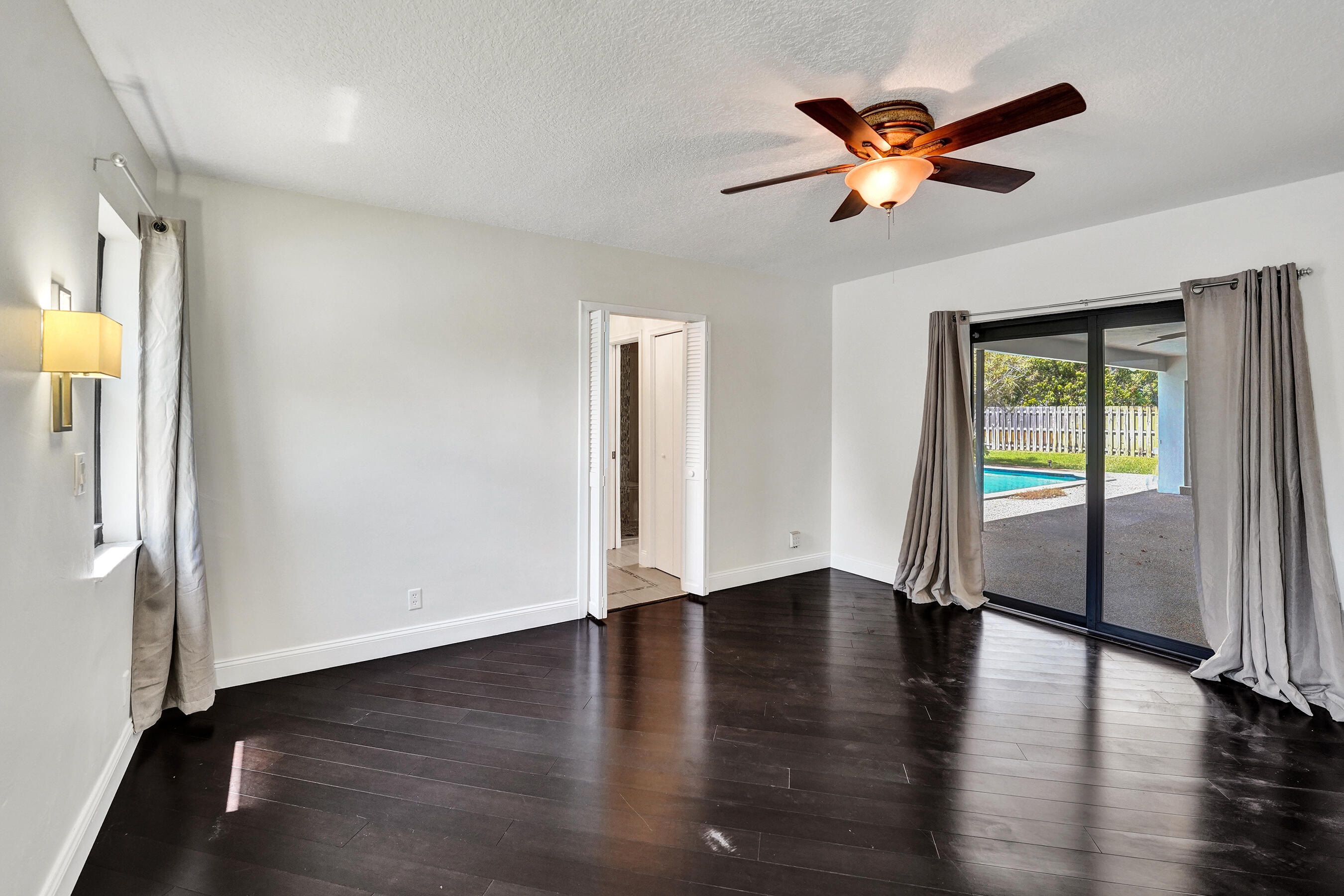1321 Southwest 74th Terrace Plantation, FL 33317 - Photo 30 of 59 an empty room with wooden floor fan and windows