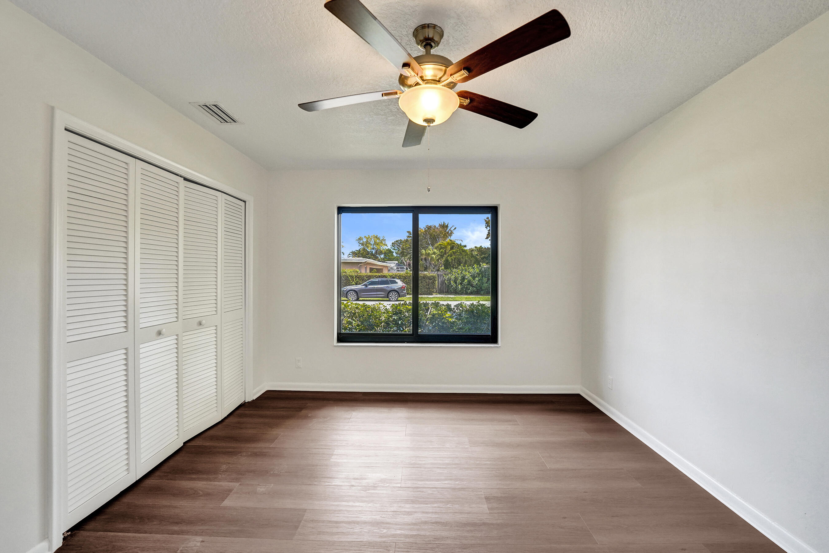 1321 Southwest 74th Terrace Plantation, FL 33317 - Photo 35 of 59 an empty room with wooden floor chandelier and windows