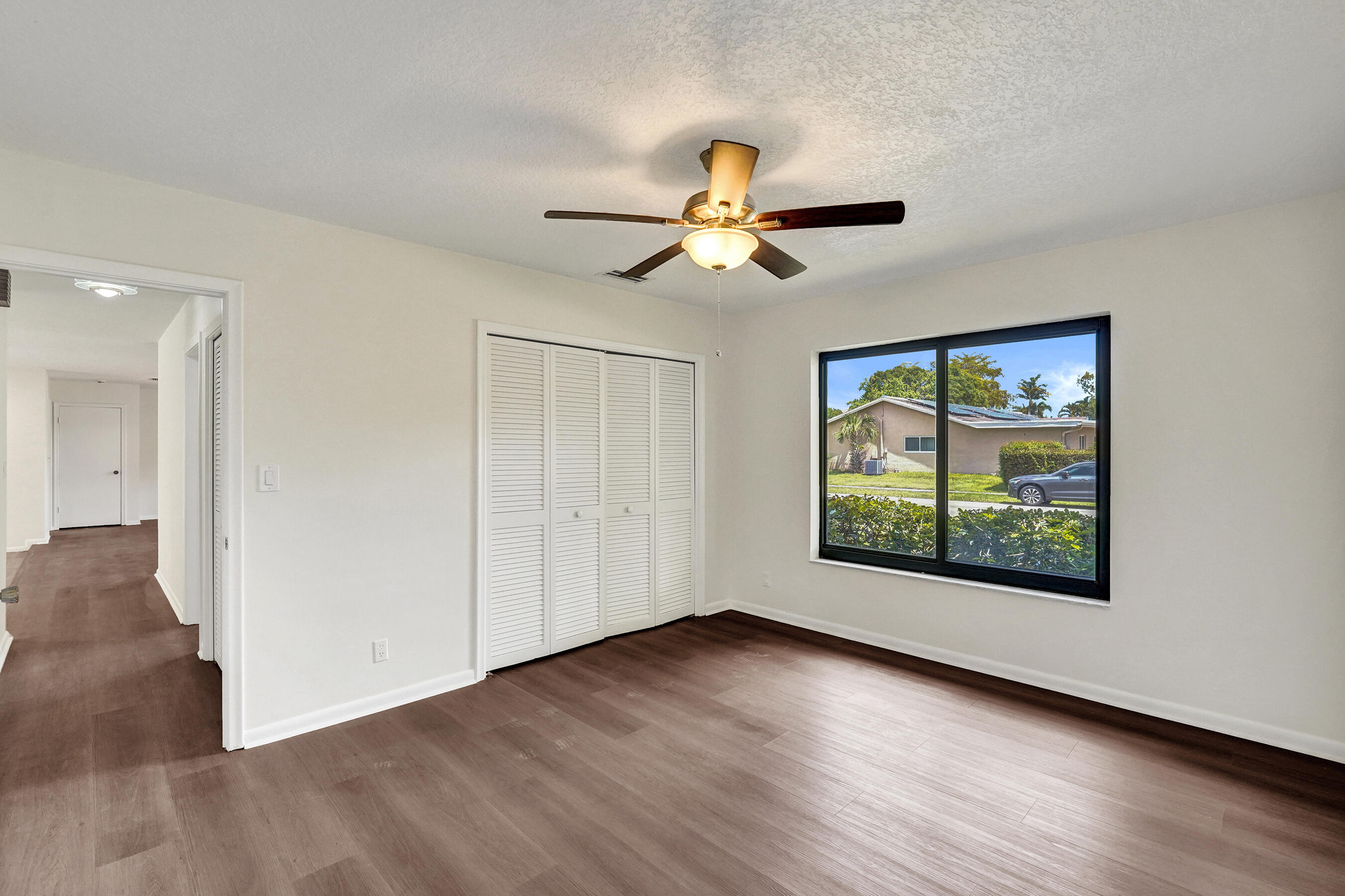1321 Southwest 74th Terrace Plantation, FL 33317 - Photo 36 of 59 a view of an empty room with window and wooden floor