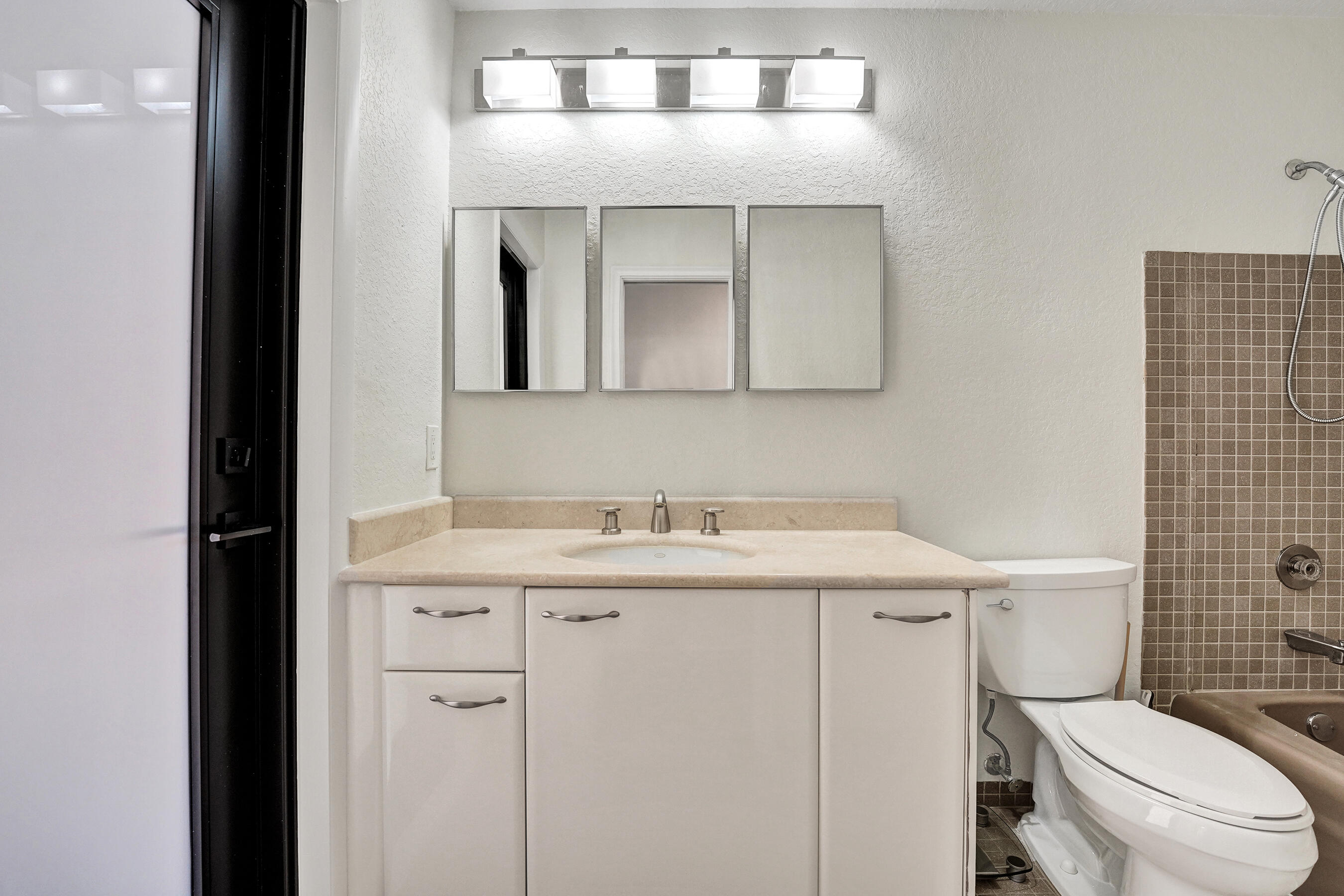 1321 Southwest 74th Terrace Plantation, FL 33317 - Photo 39 of 59 a bathroom with a toilet a sink and mirror