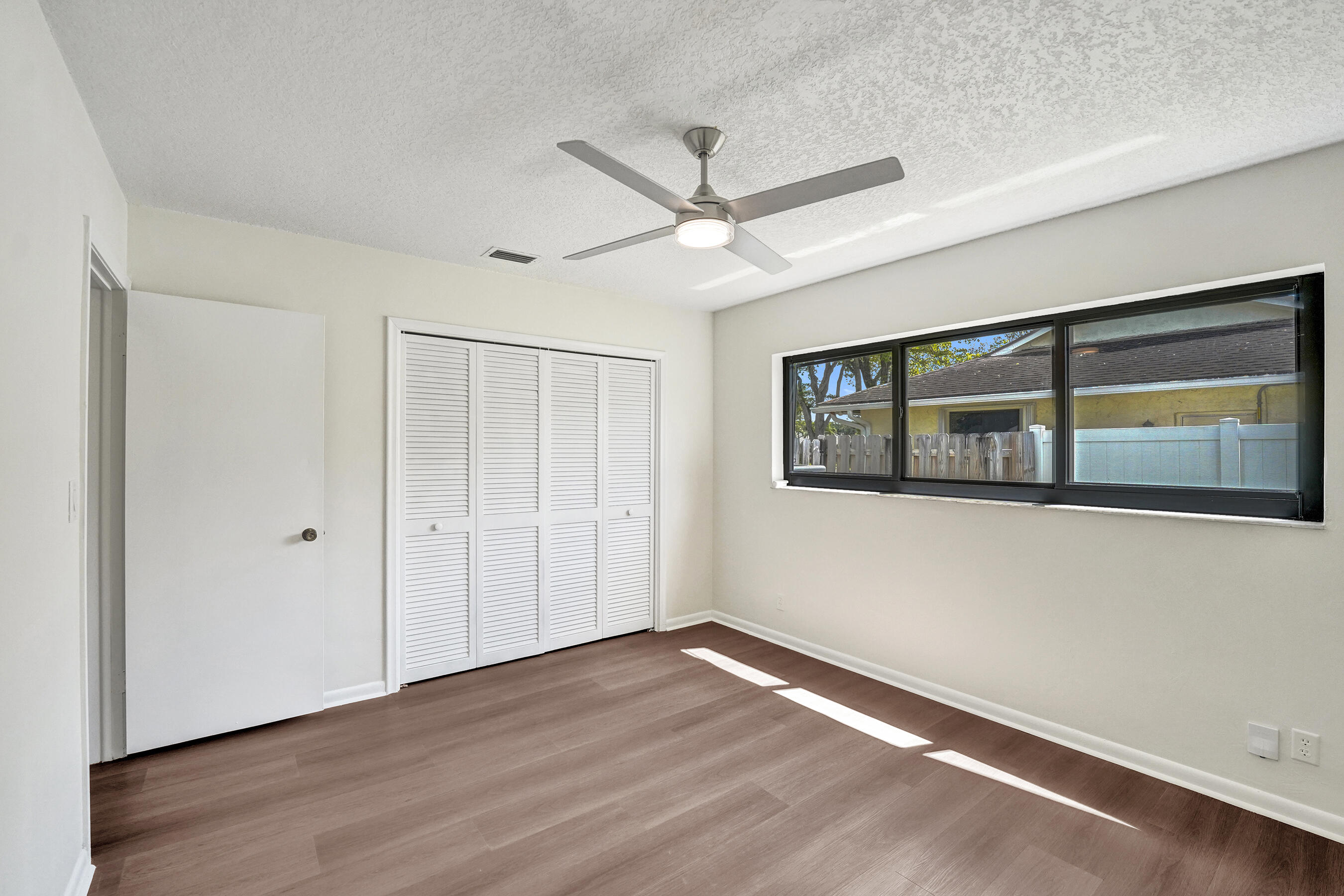 1321 Southwest 74th Terrace Plantation, FL 33317 - Photo 41 of 59 a view of an empty room with wooden floor and a window