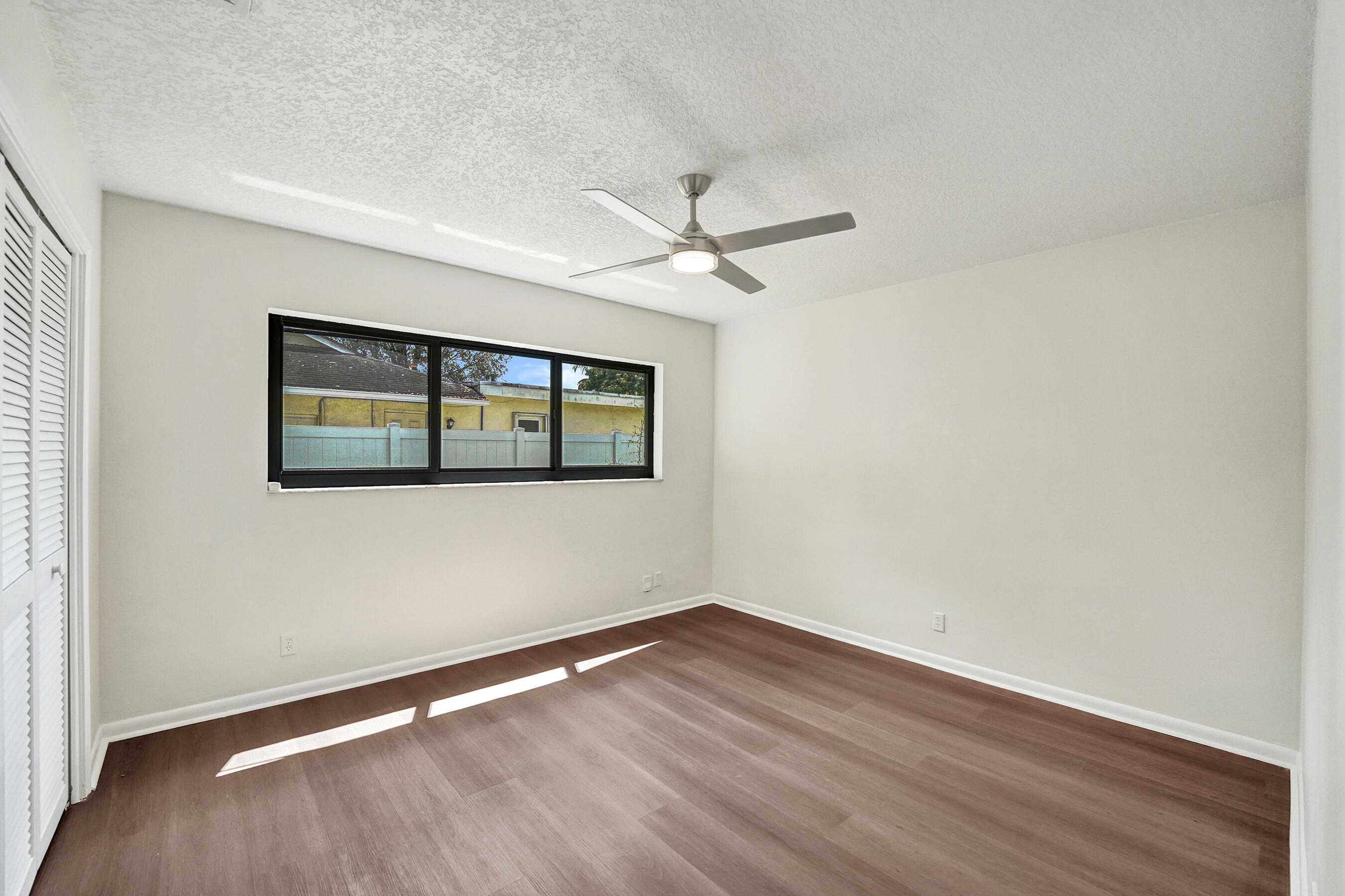 1321 Southwest 74th Terrace Plantation, FL 33317 - Photo 42 of 59 a view of empty room with wooden floor and fan