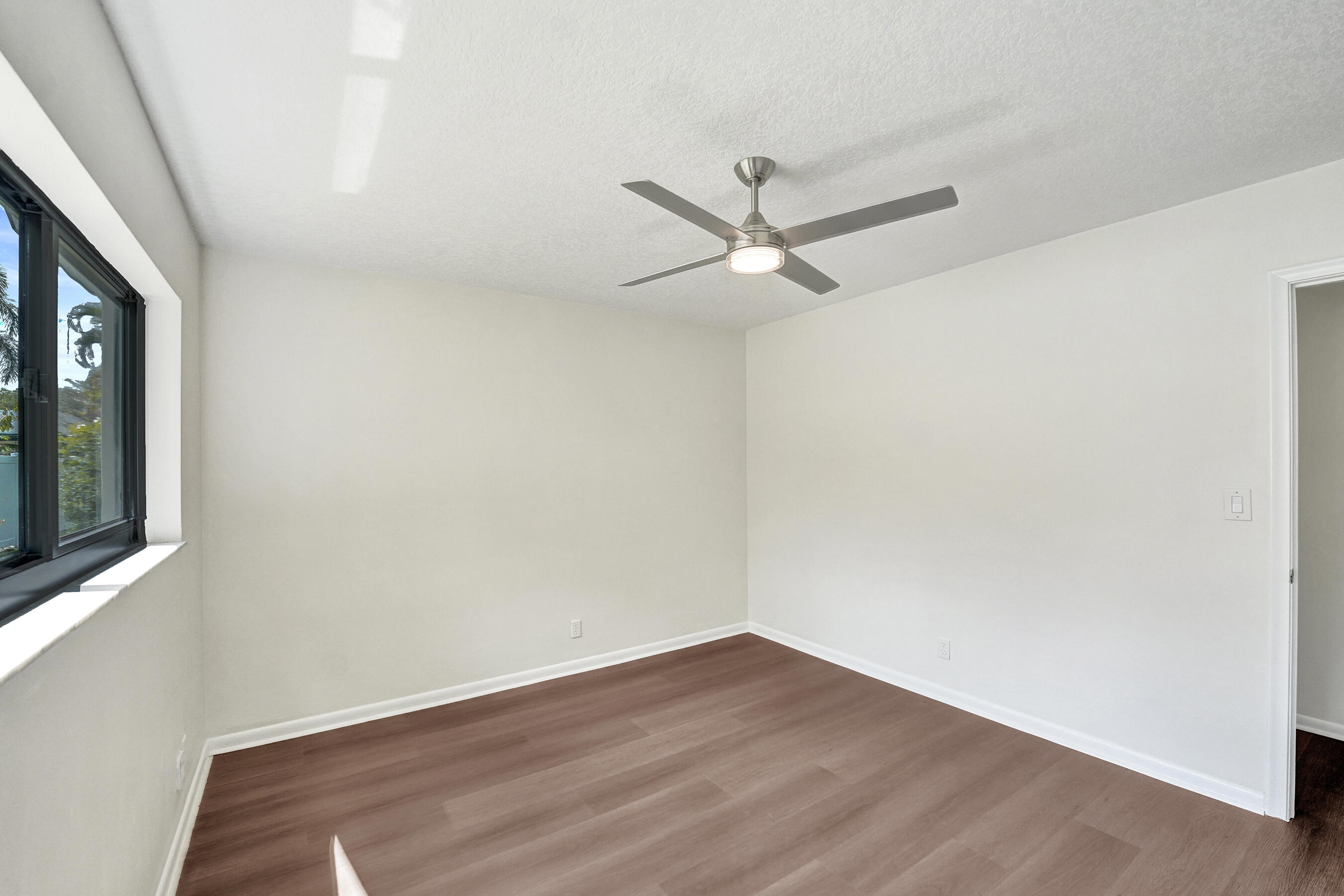 1321 Southwest 74th Terrace Plantation, FL 33317 - Photo 43 of 59 an empty room with wooden floor and windows