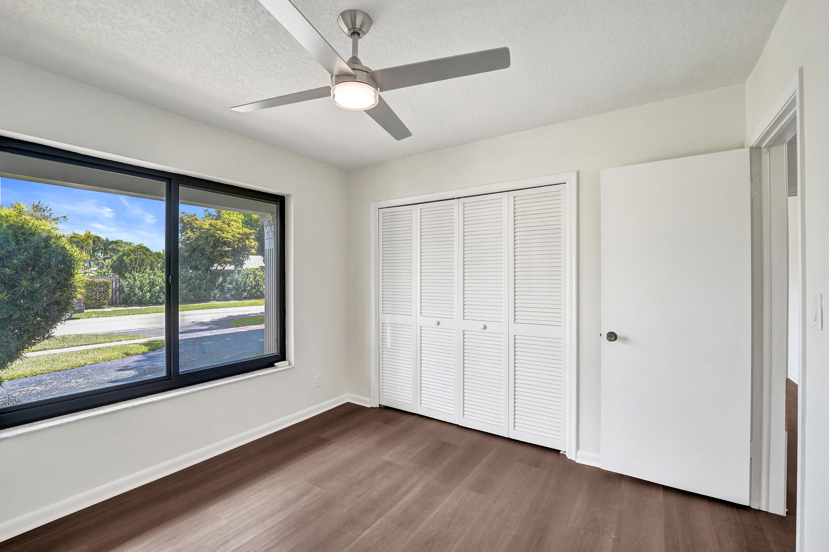 1321 Southwest 74th Terrace Plantation, FL 33317 - Photo 45 of 59 an empty room with wooden floor and windows