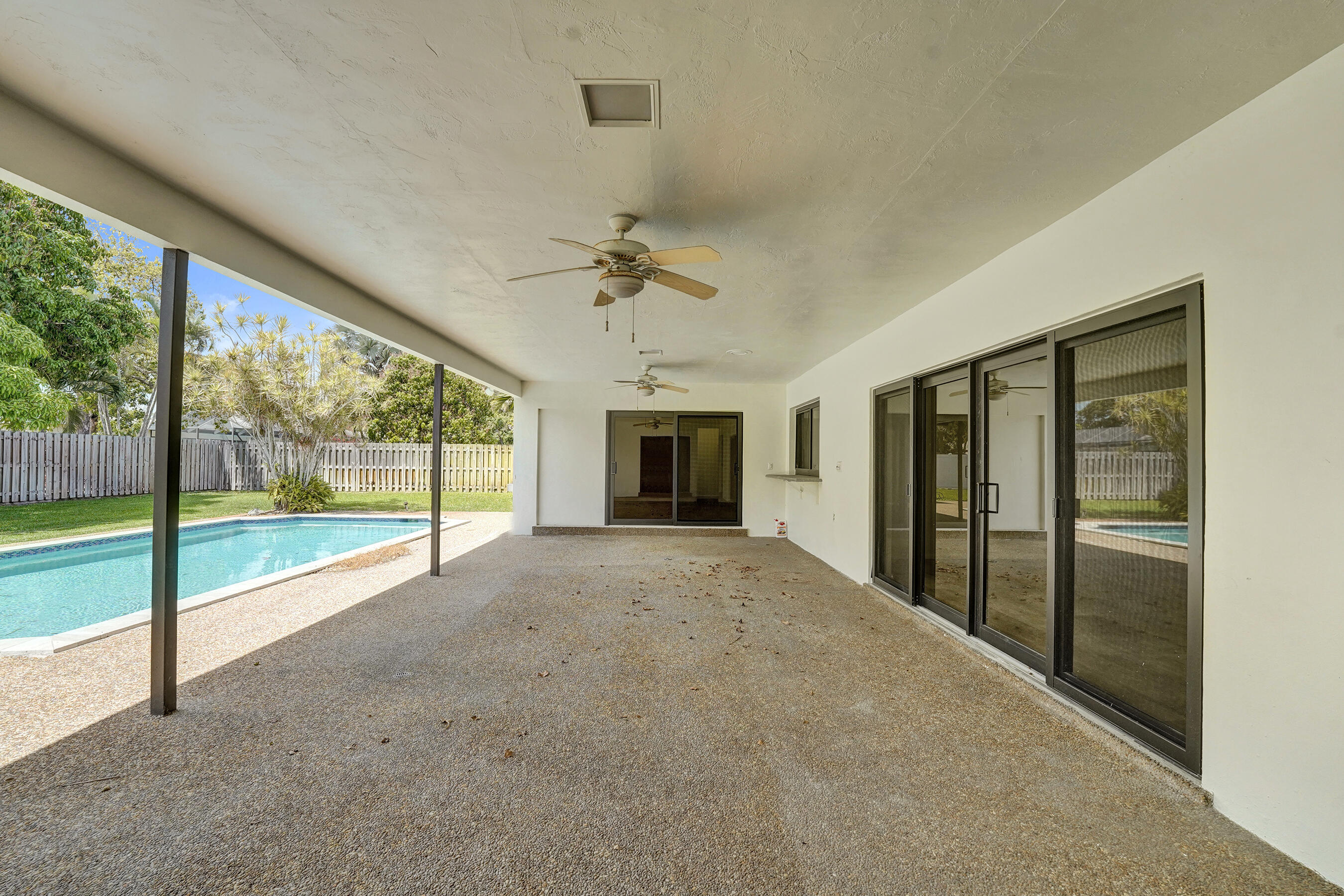 1321 Southwest 74th Terrace Plantation, FL 33317 - Photo 52 of 59 a view of an empty room with a fireplace and a large window