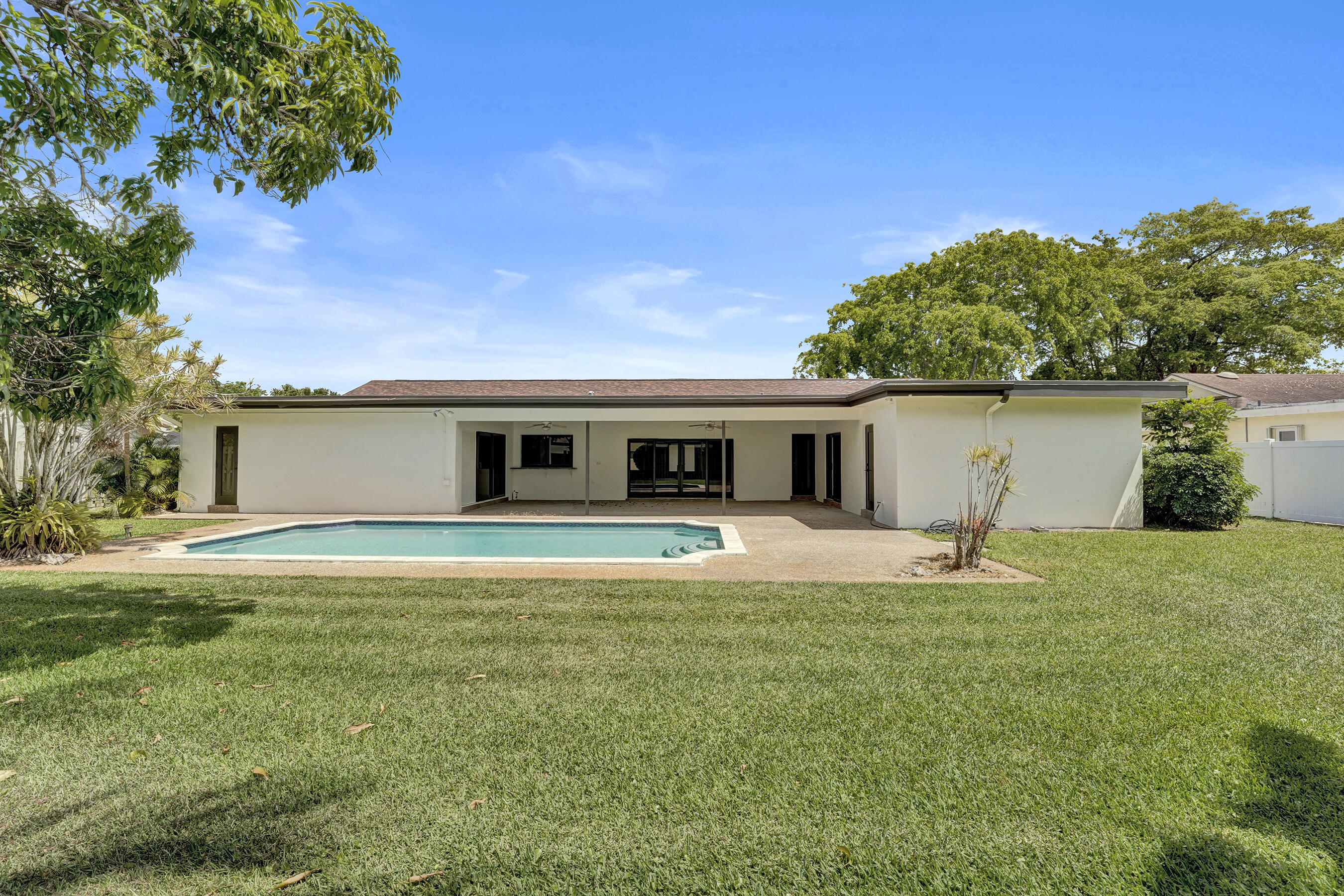 1321 Southwest 74th Terrace Plantation, FL 33317 - Photo 57 of 59 a front view of house with yard and trees in the background