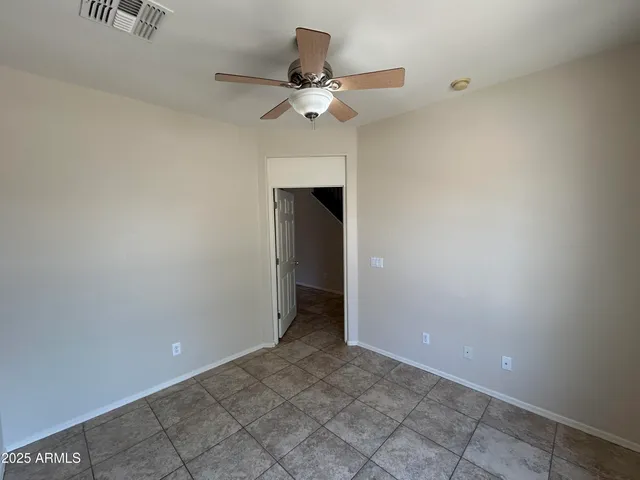 a view of a livingroom with a ceiling fan and carpet