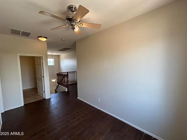 a view of an empty room and wooden floor