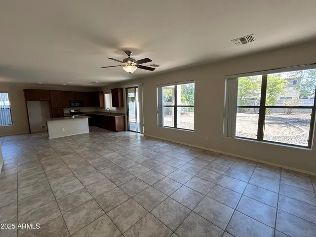 a view of a livingroom with furniture and chandelier fan