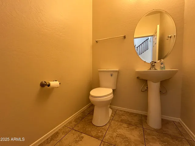 a bathroom with a toilet mirror and vanity