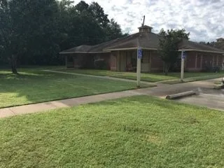 a view of a house with a backyard