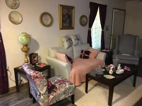 a living room with furniture and a mirror