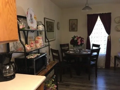 a view of a dining room with furniture and wooden floor