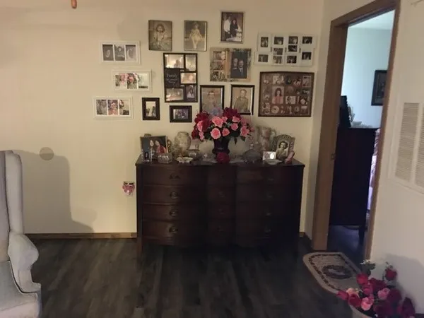 a bed sitting in a bedroom next to a lamp on dresser