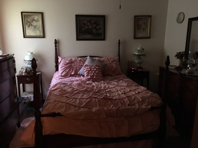500 Danville Road Kilgore, TX 75662 - Photo 21 of 22 a bed sitting in a bedroom next to a lamp on dresser