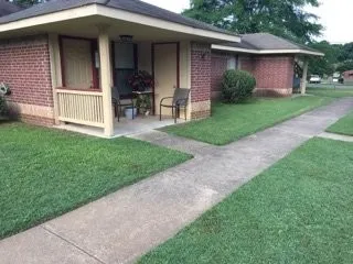 a view of a house with a yard chairs and table and chairs