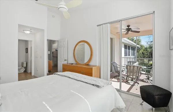 a bedroom with a large bed and a chandelier