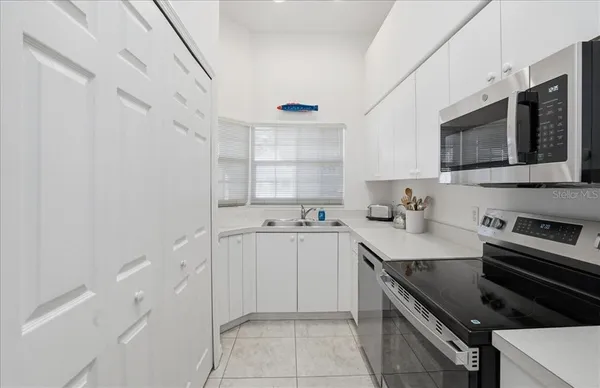 a kitchen with stainless steel appliances a sink stove and cabinets